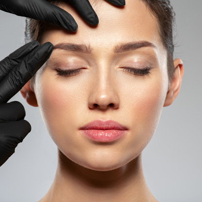 doctor-examining-a-patient's-brow-area