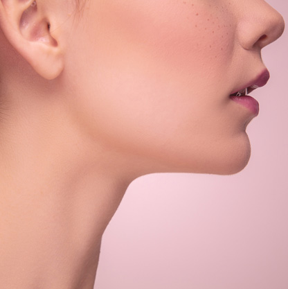 side-profile-of-a-woman-isolated-on-light-pink-studio-background